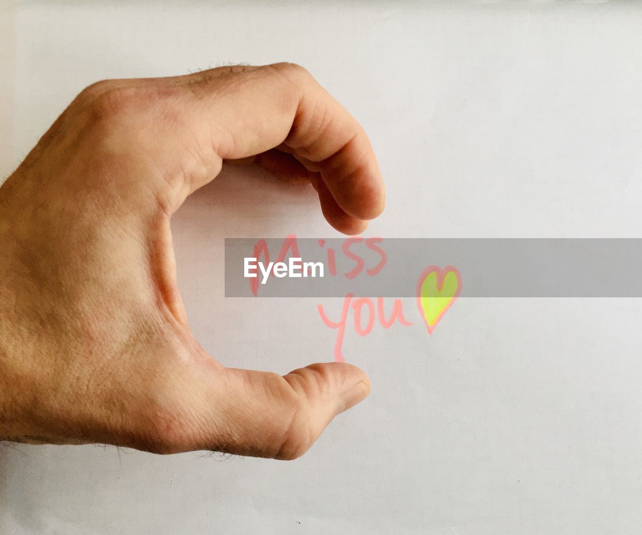 hand, text, one person, finger, indoors, western script, communication, positive emotion, close-up, heart shape, arm, writing, emotion, handwriting, men, creativity, holding, love, message, adult, studio shot