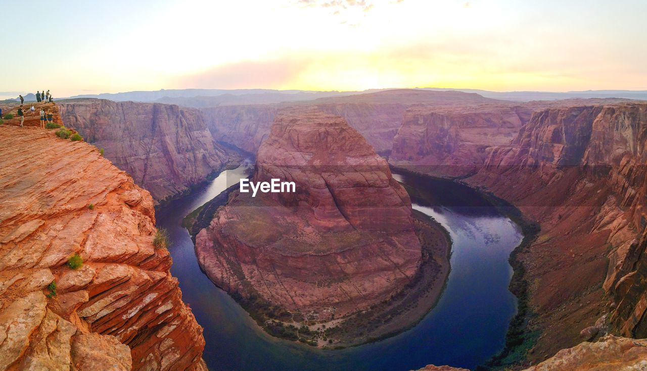 Scenic view of horseshoe bend against sky during sunset