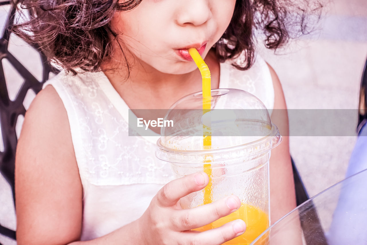 Close-up of girl having drink