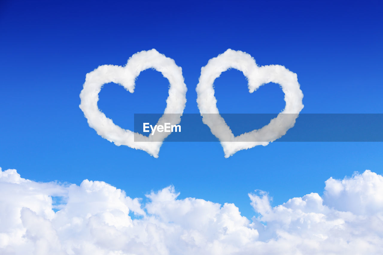 LOW ANGLE VIEW OF HEART SHAPE ON WHITE BLUE SKY