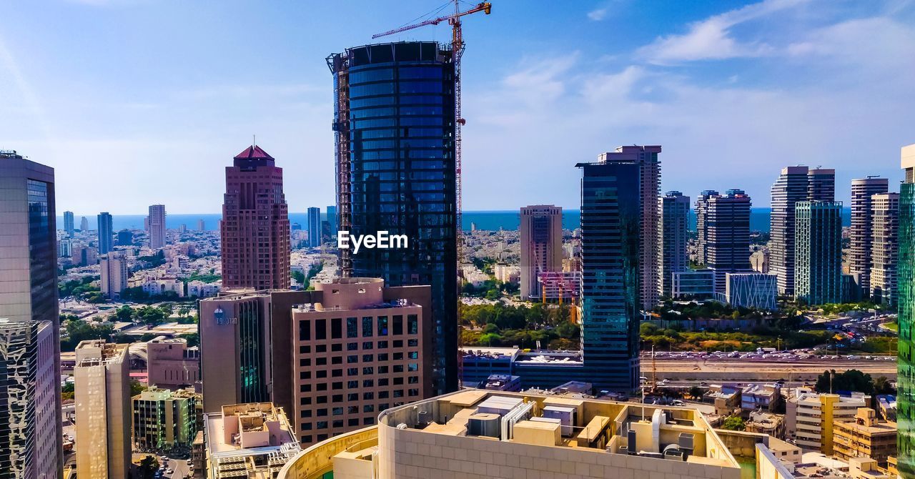 SKYSCRAPERS IN CITY AGAINST SKY