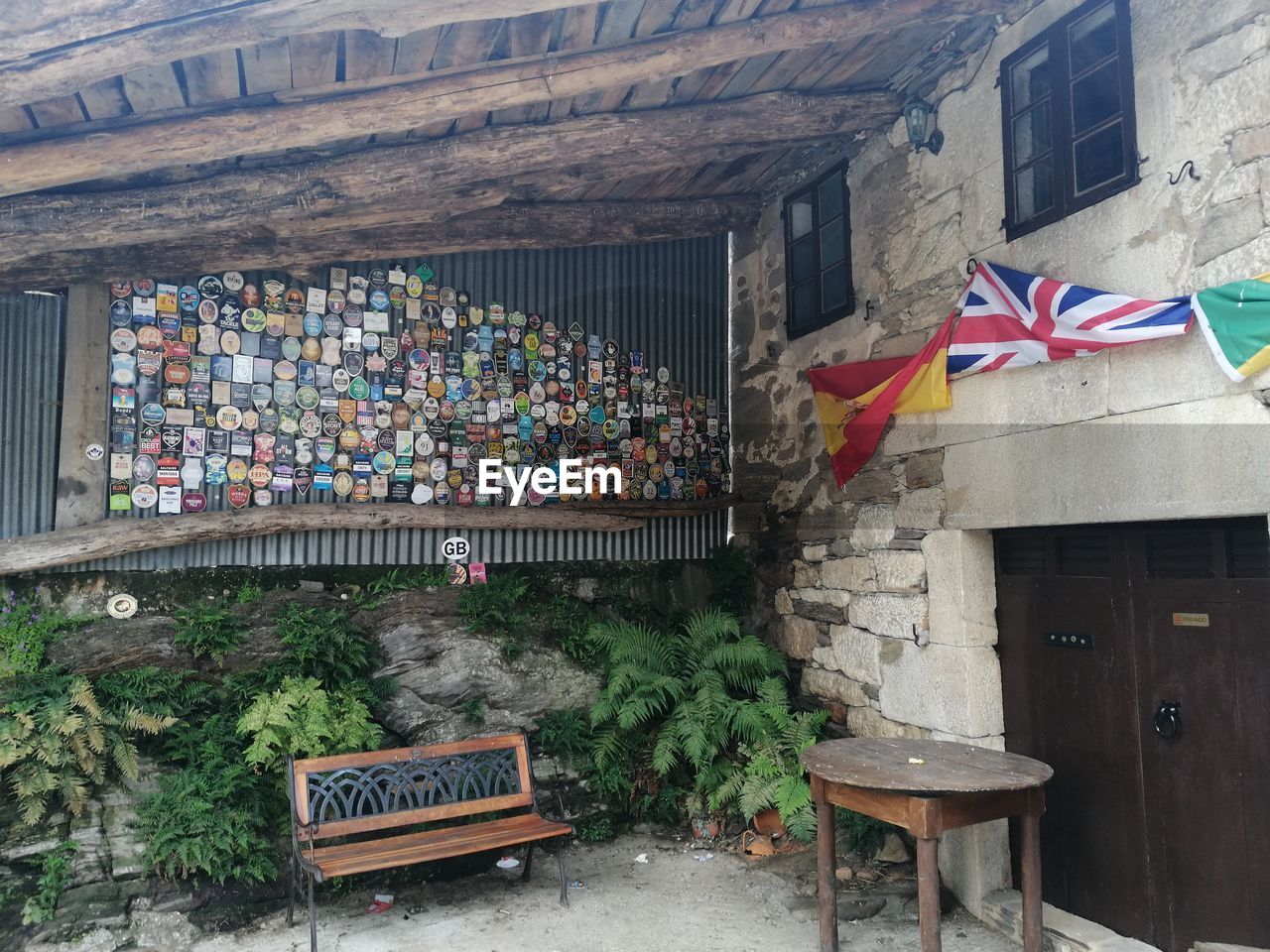 architecture, urban area, flag, wall, built structure, building exterior, no people, seat, day, patriotism, furniture, outdoors, building, art, nature, chair, bench, multi colored, town