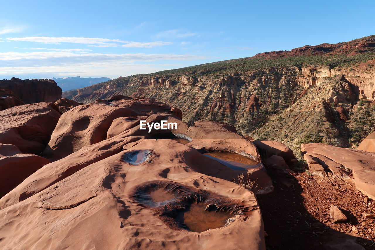 Rock formations on land against sky