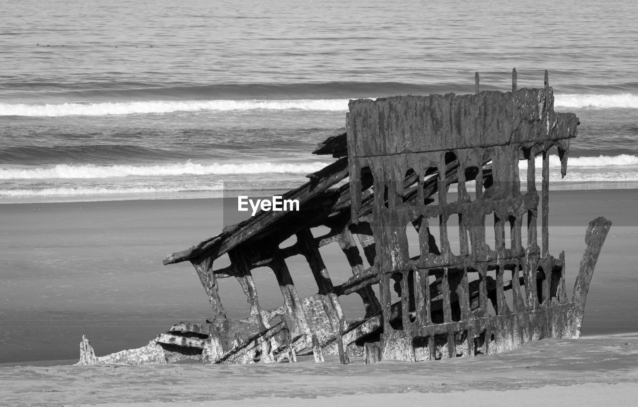 ABANDONED DECK CHAIRS ON BEACH