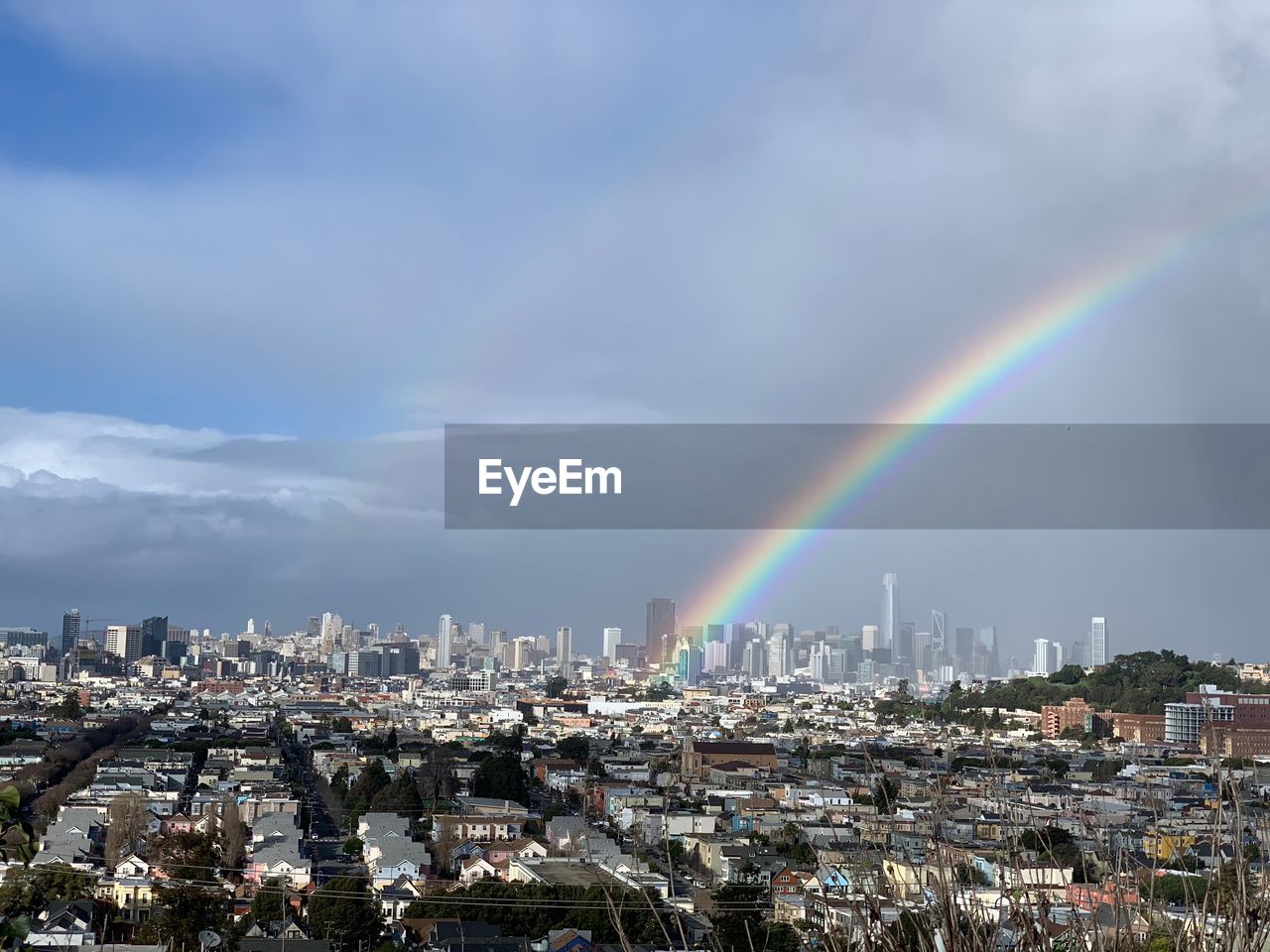 AERIAL VIEW OF RAINBOW OVER CITY BUILDINGS