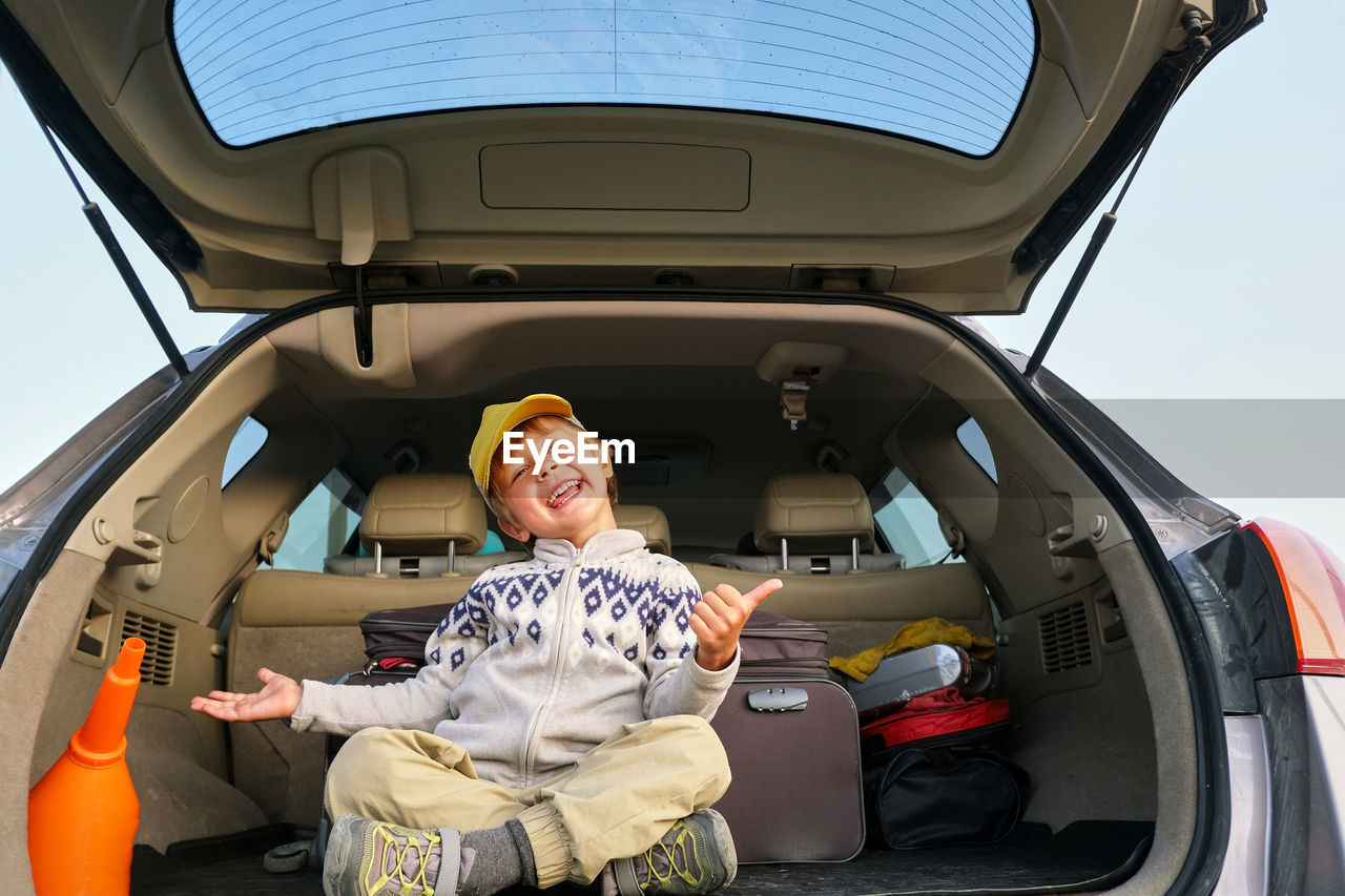 Portrait of smiling man sitting in car