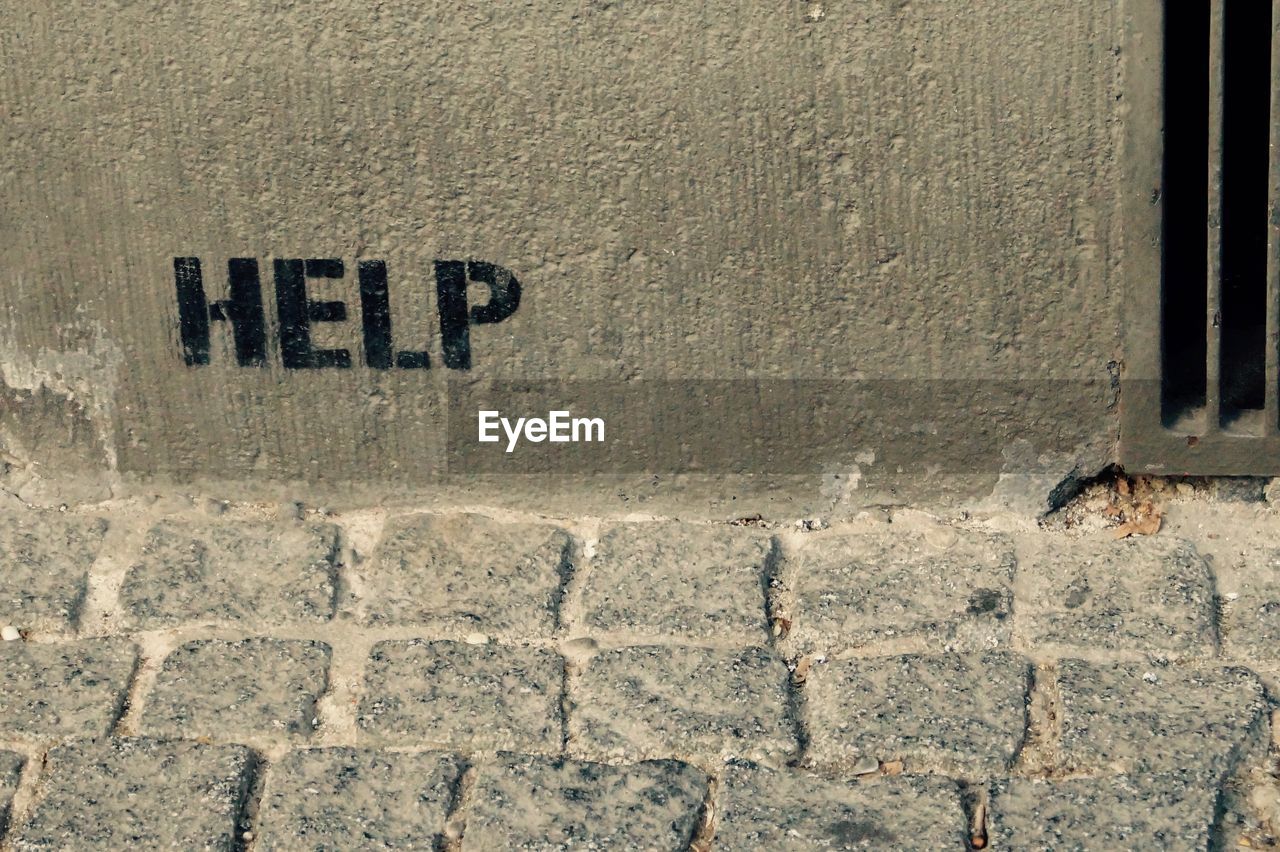 High angle view of help text on wall
