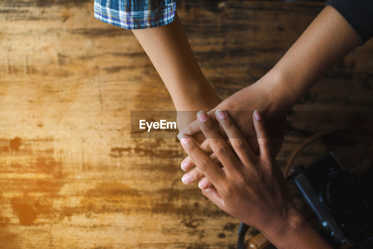 Cropped hands of business people doing hand stack in office