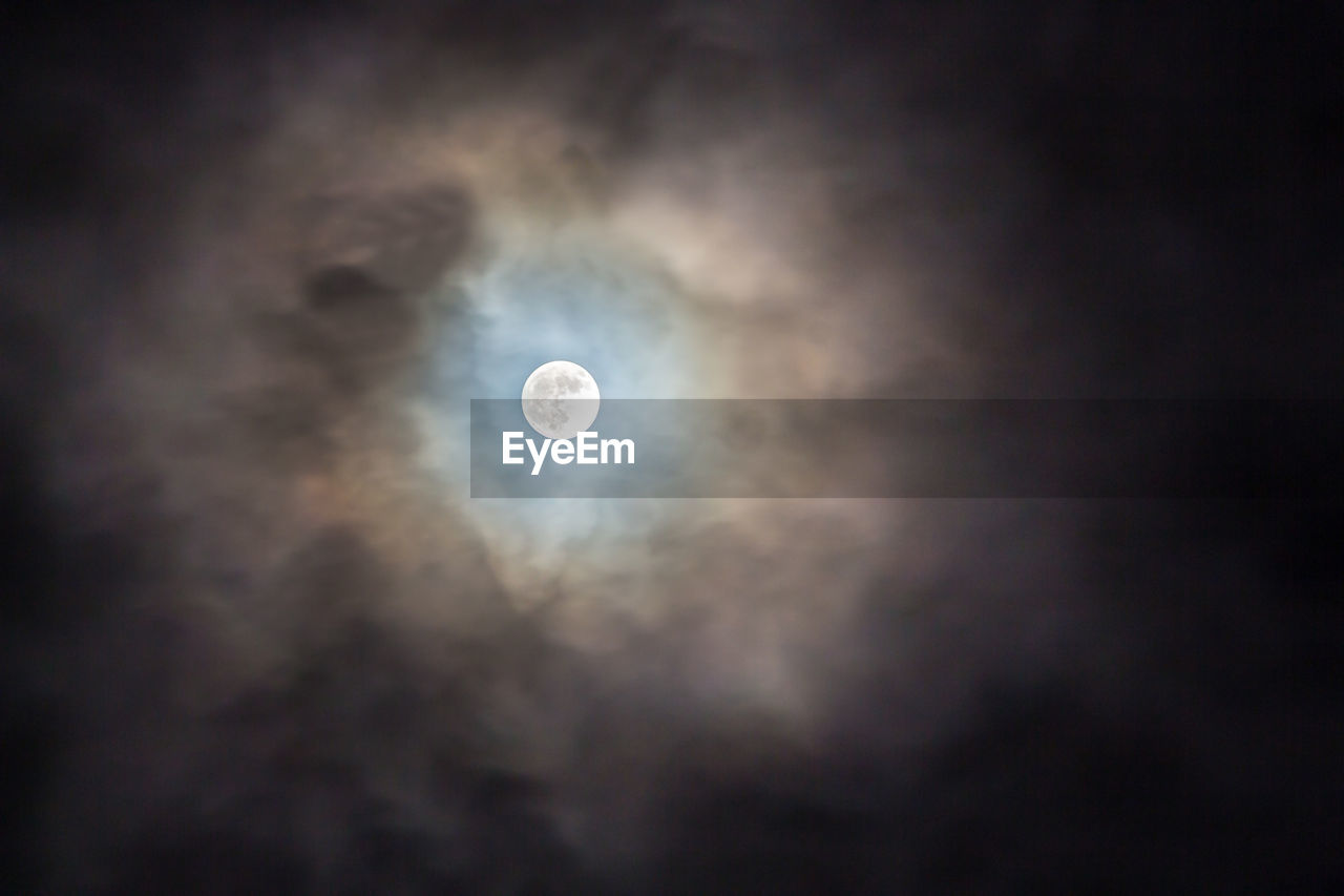 LOW ANGLE VIEW OF MOON IN SKY AT NIGHT