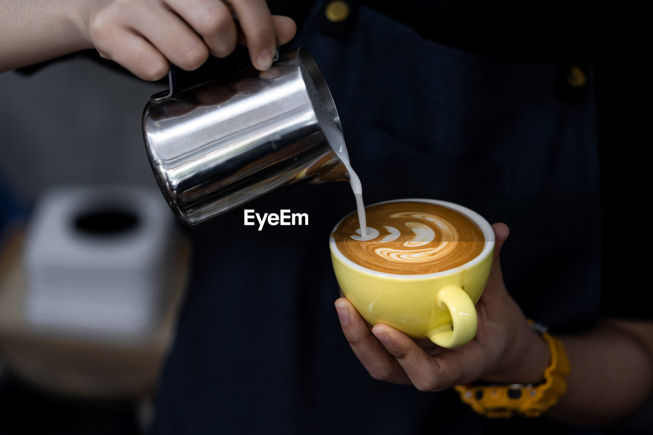 Cropped image of person making coffee