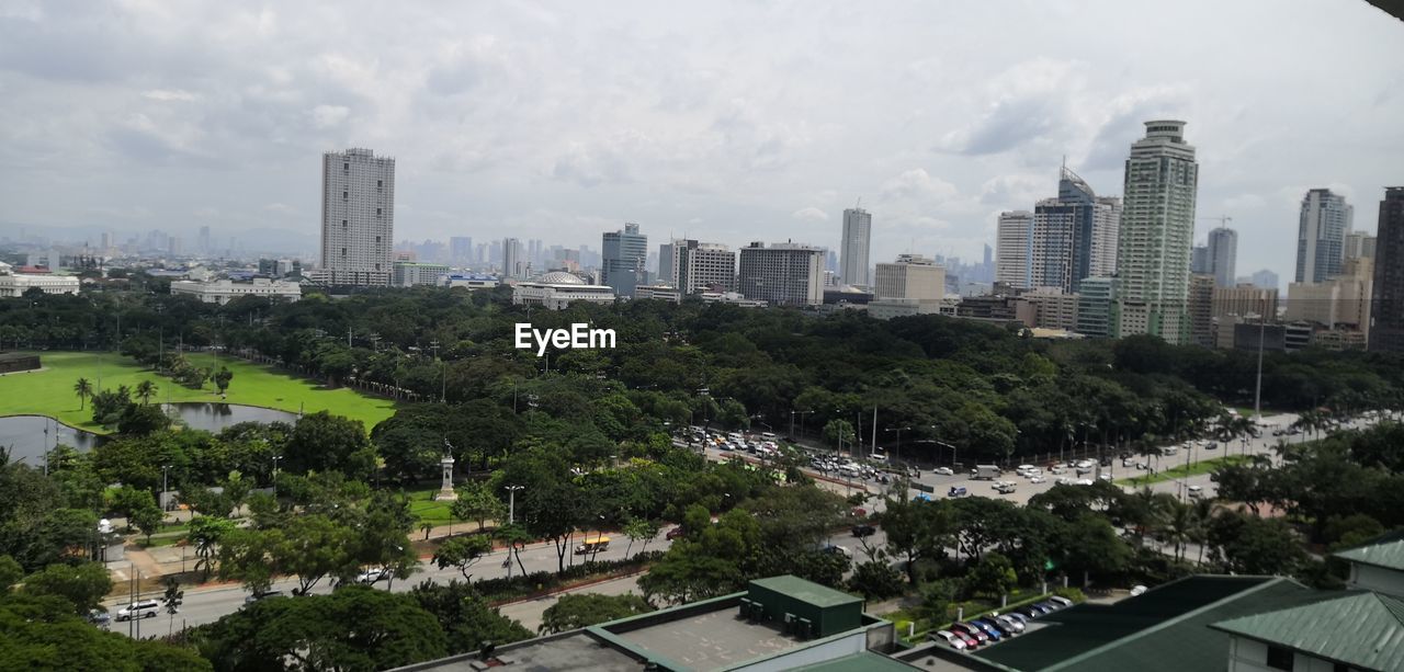 Aerial view of buildings in city against sky