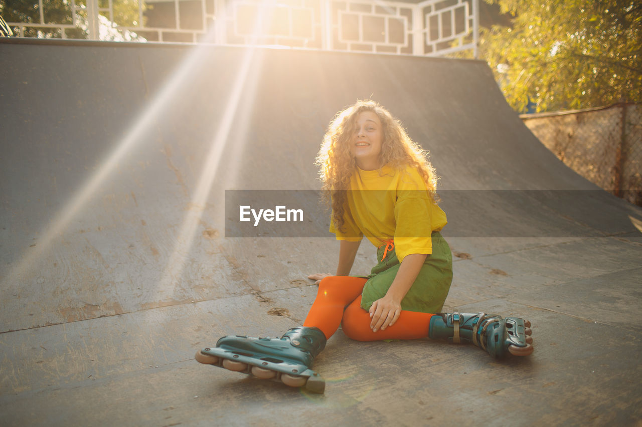 Portrait of smiling woman skating on ramp