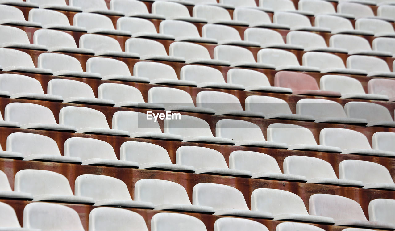 Full frame shot of empty chairs at stadium