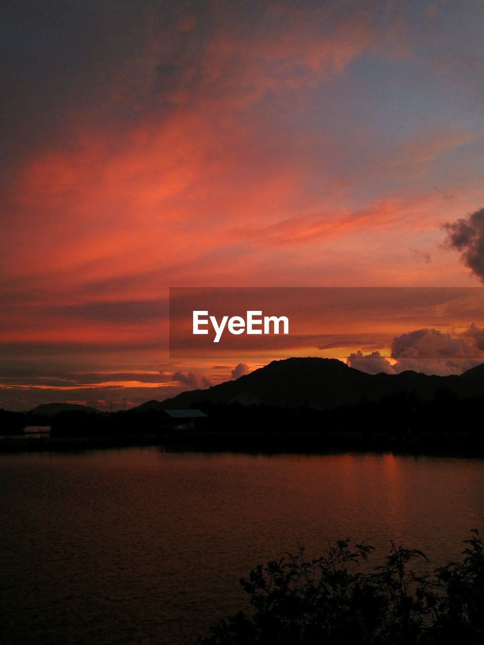 SCENIC VIEW OF LAKE AGAINST ORANGE SKY