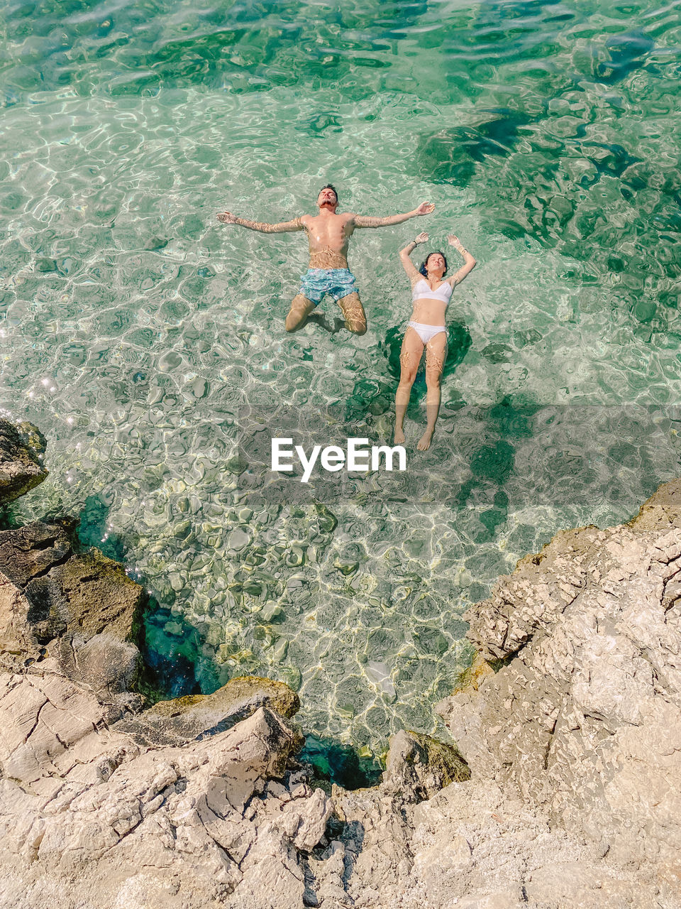 High angle view of couple enjoying at sea shore