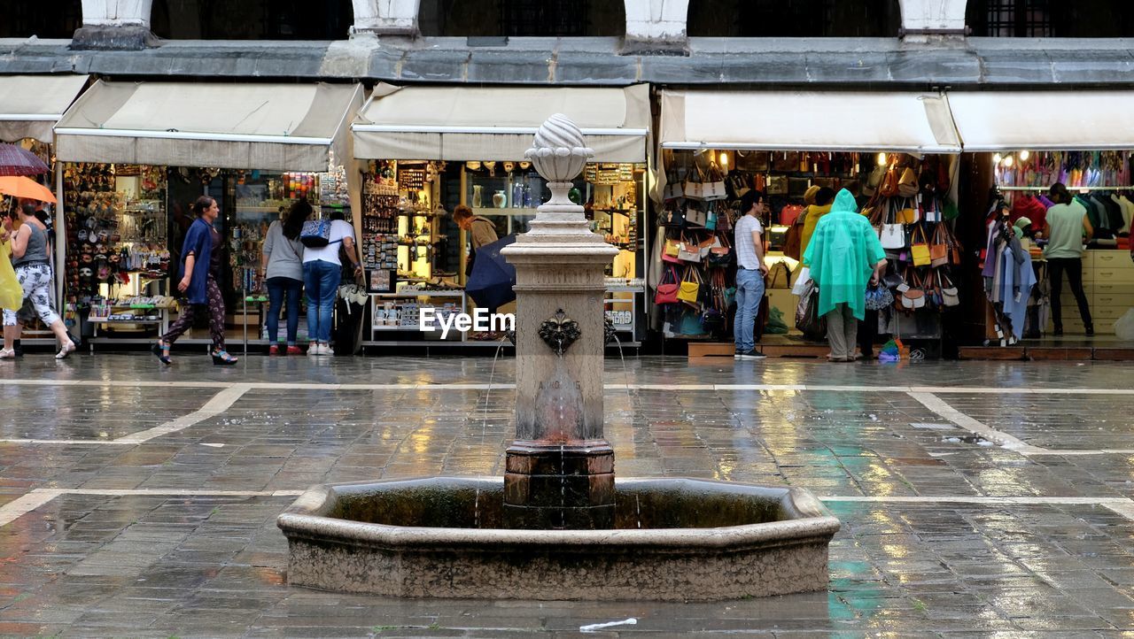 PEOPLE IN FRONT OF CITY IN TOWN SQUARE