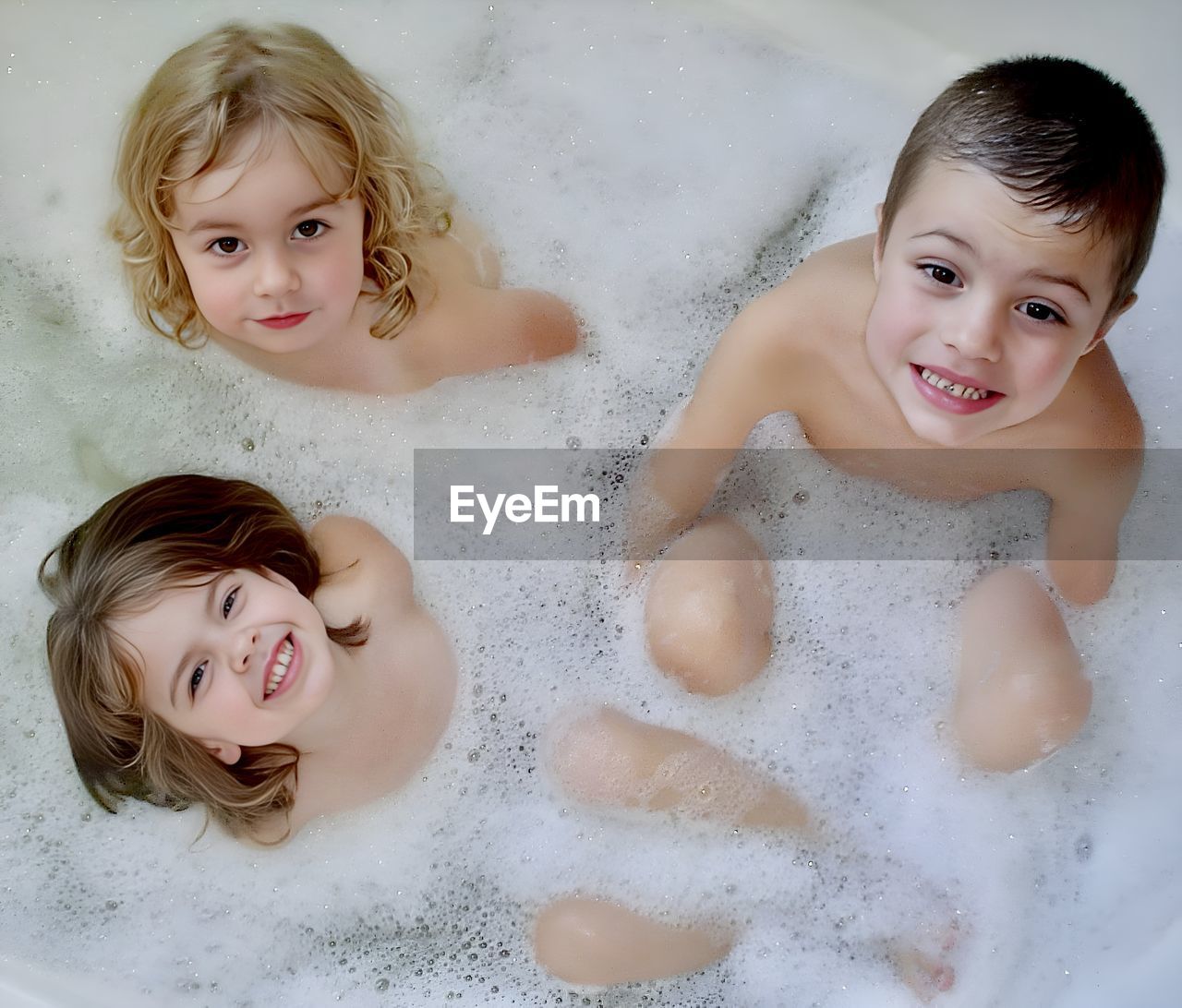 High angle view of three children in the bath 