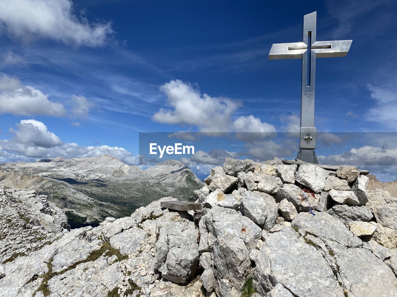 LOW ANGLE VIEW OF CROSS ON ROCKS AGAINST SKY