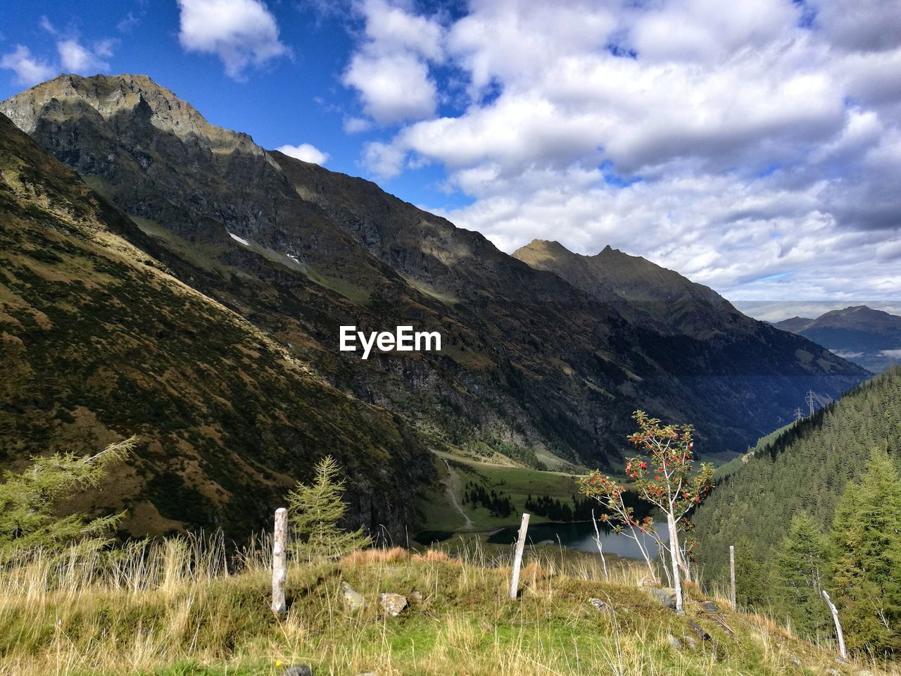 SCENIC VIEW OF MOUNTAINS AGAINST CLOUDY SKY