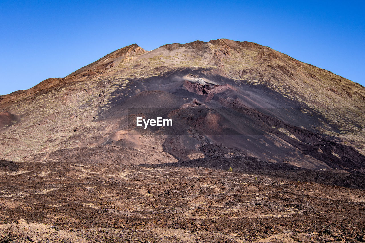 Scenic view of volcanic mountains against clear sky