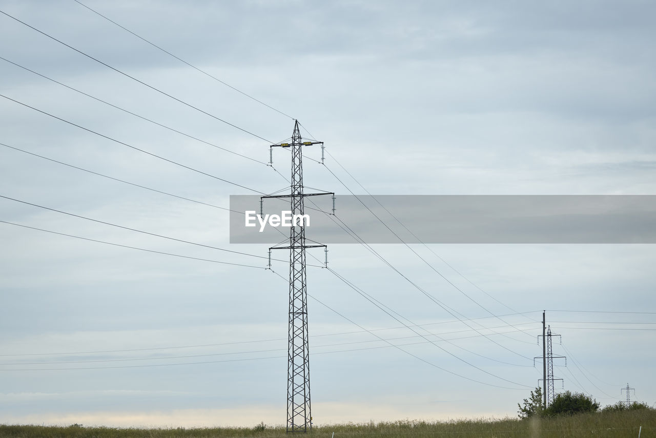 Low angle view of electricity pylon against sky