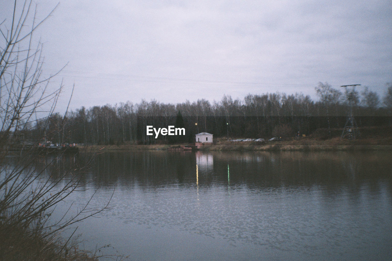 LAKE AND TREES AGAINST SKY