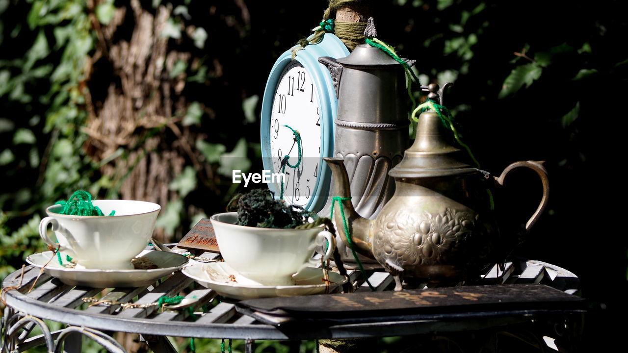 TEA CUP ON TABLE AGAINST CLEAR SKY