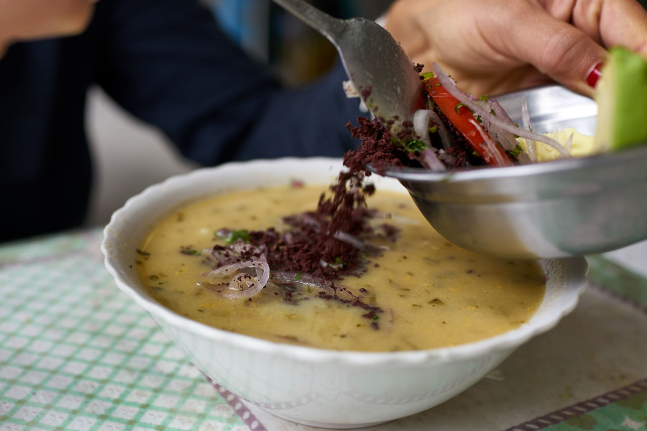 MIDSECTION OF PERSON PREPARING FOOD IN BOWL