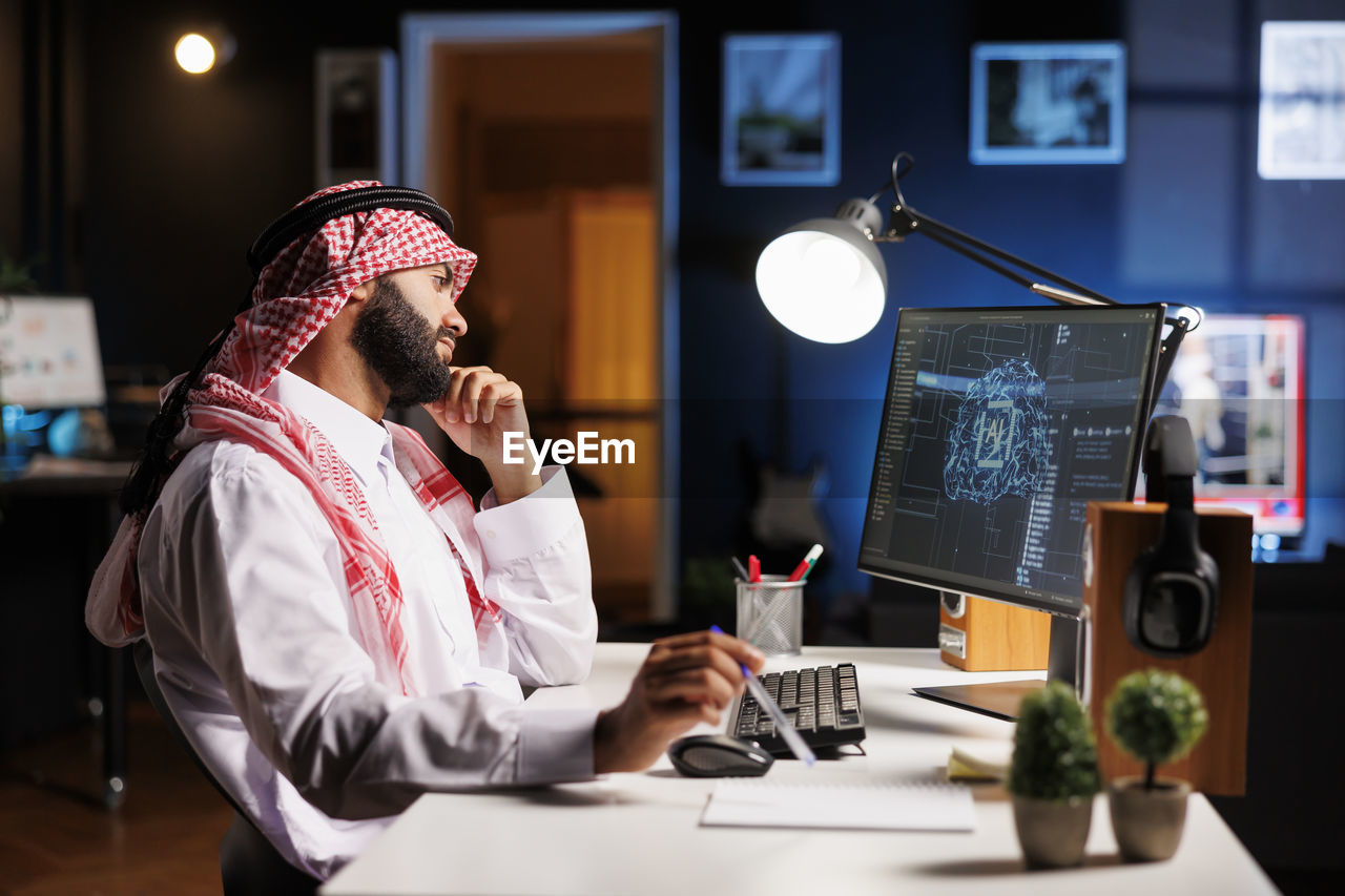 midsection of businessman working at desk