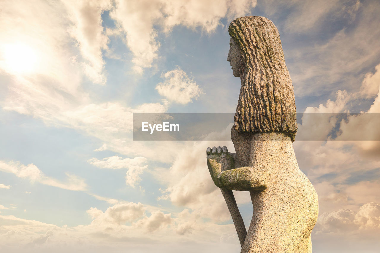 cloud, sky, statue, nature, monument, sculpture, art, representation, creativity, sunlight, outdoors, no people, environment, day, sunset, human representation, craft, beauty in nature, low angle view