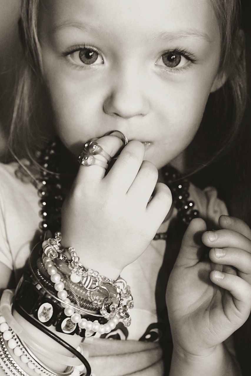 Portrait of girl wearing necklaces and bracelets