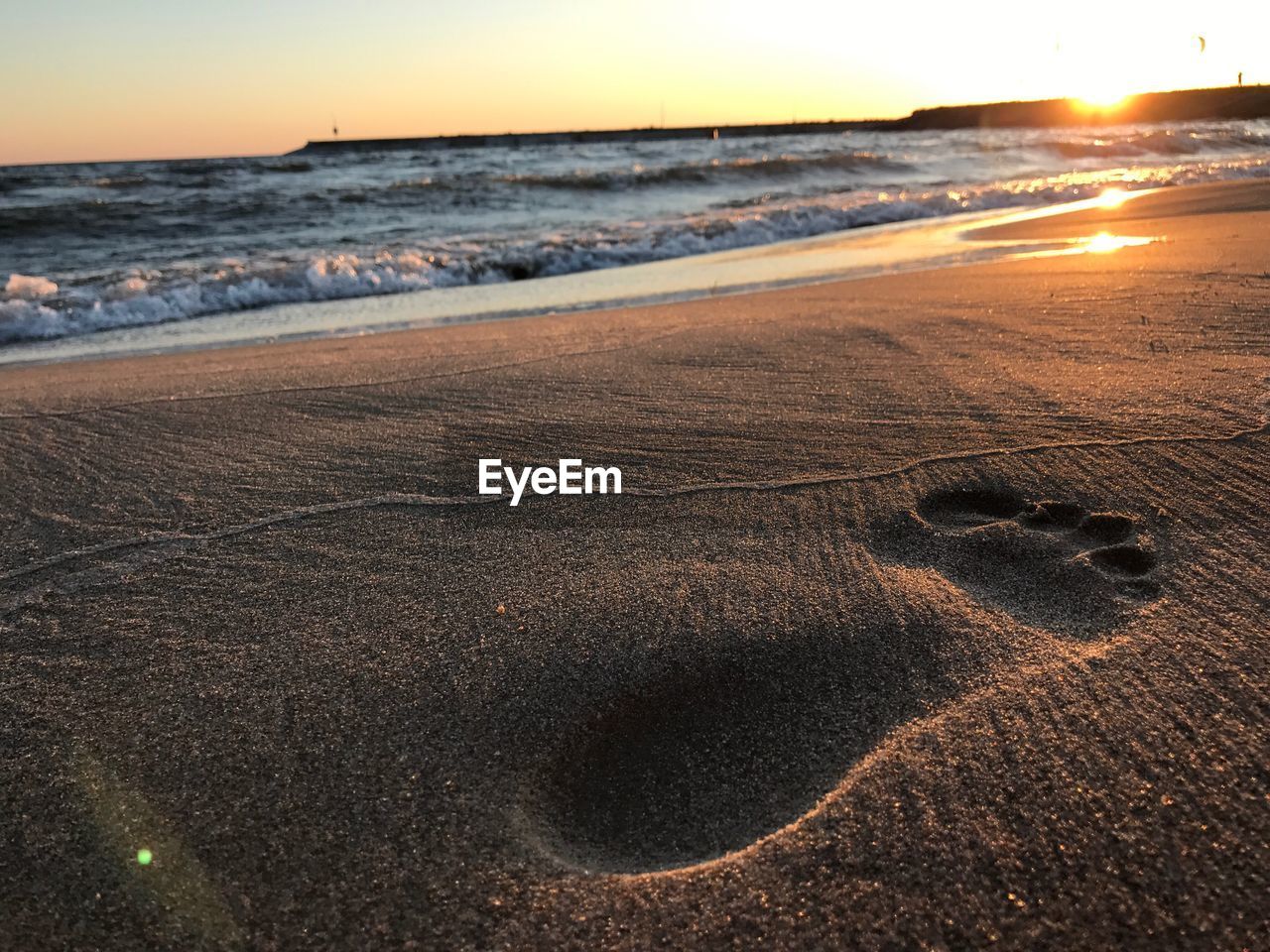 Scenic view of beach against sky during sunset