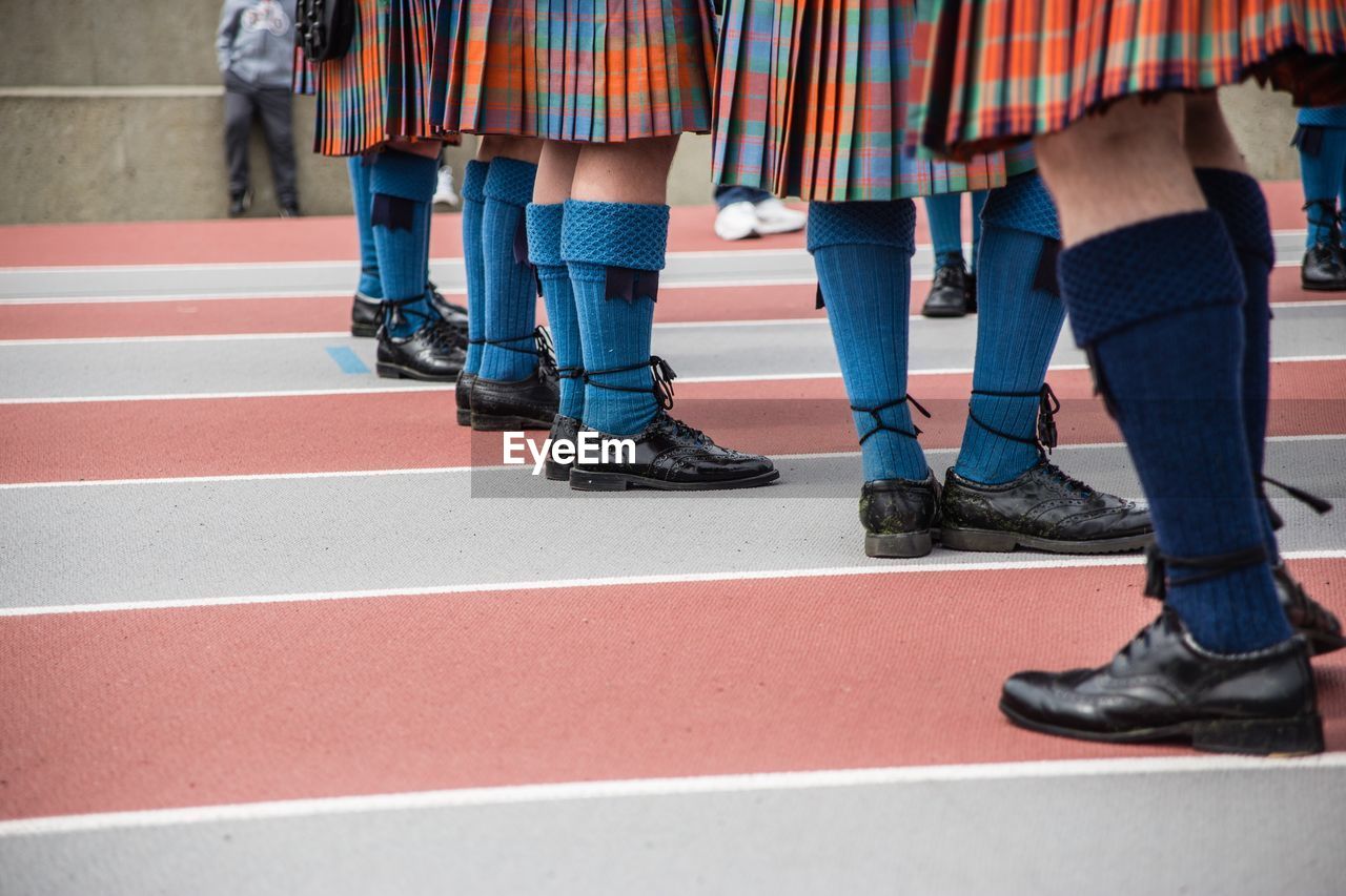 Low section of schoolgirls standing on ground