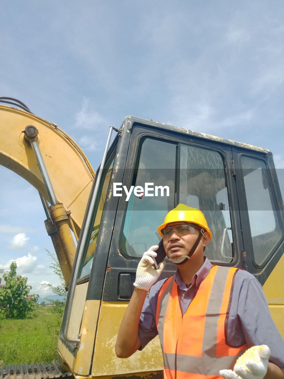 PORTRAIT OF MATURE MAN AGAINST YELLOW SKY