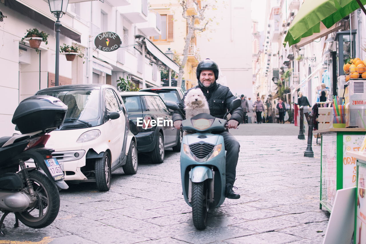 PORTRAIT OF PEOPLE RIDING MOTORCYCLE ON STREET