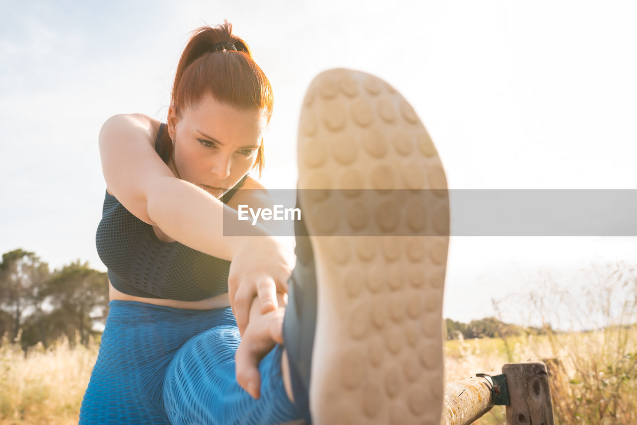 Female athlete stretching outdoors