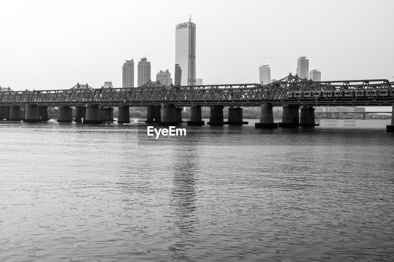 Hangang railway bridge in black and white with the view of 63 building. seoul, south korea