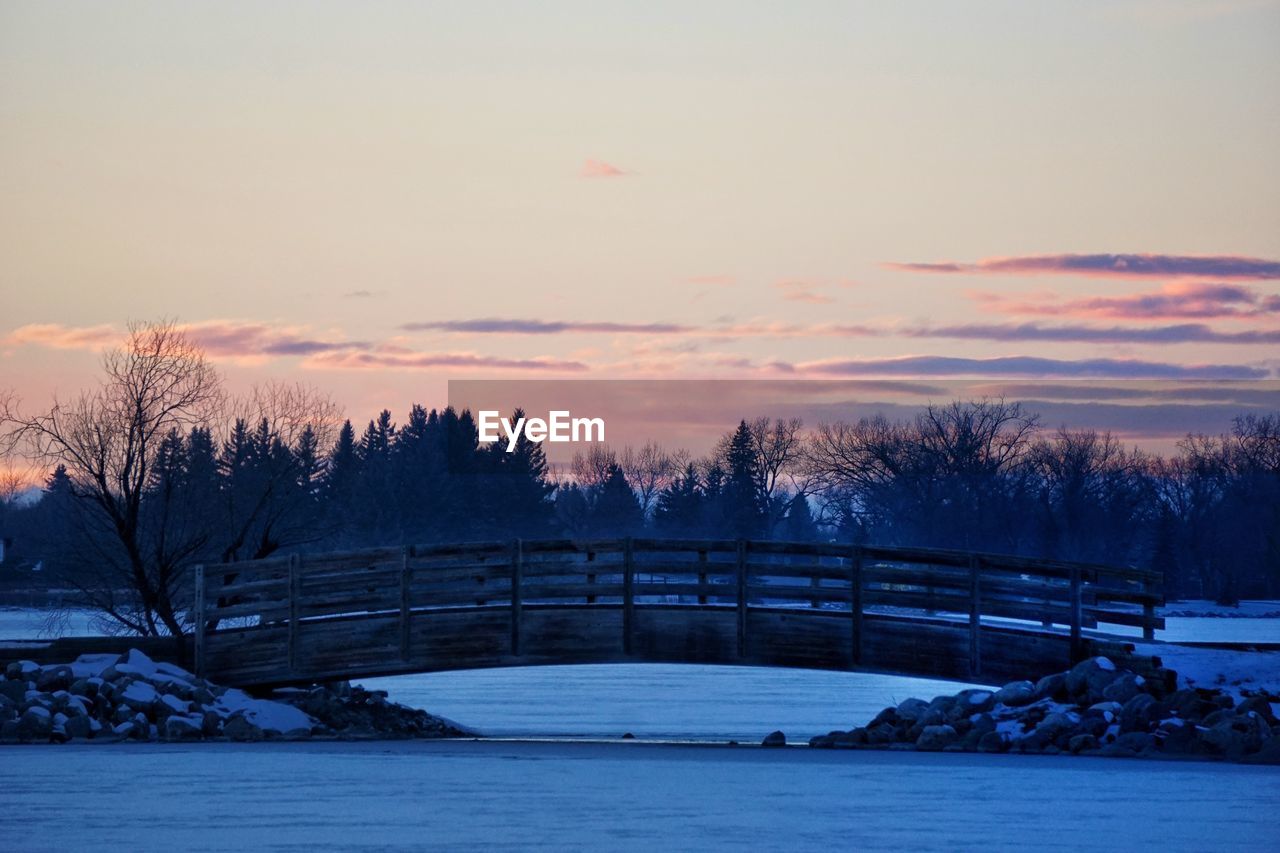 Scenic view of river at sunset