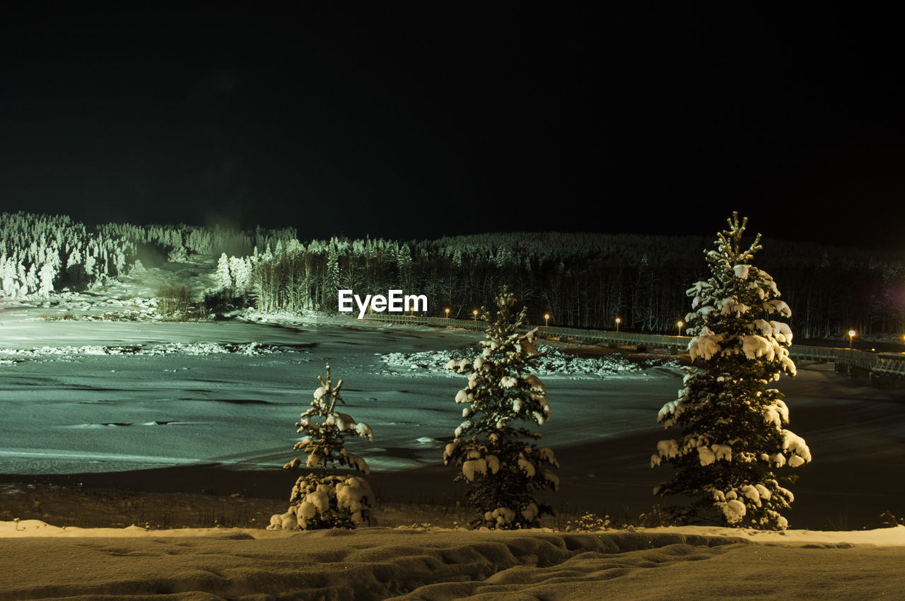 Scenic view of lake against clear sky at night