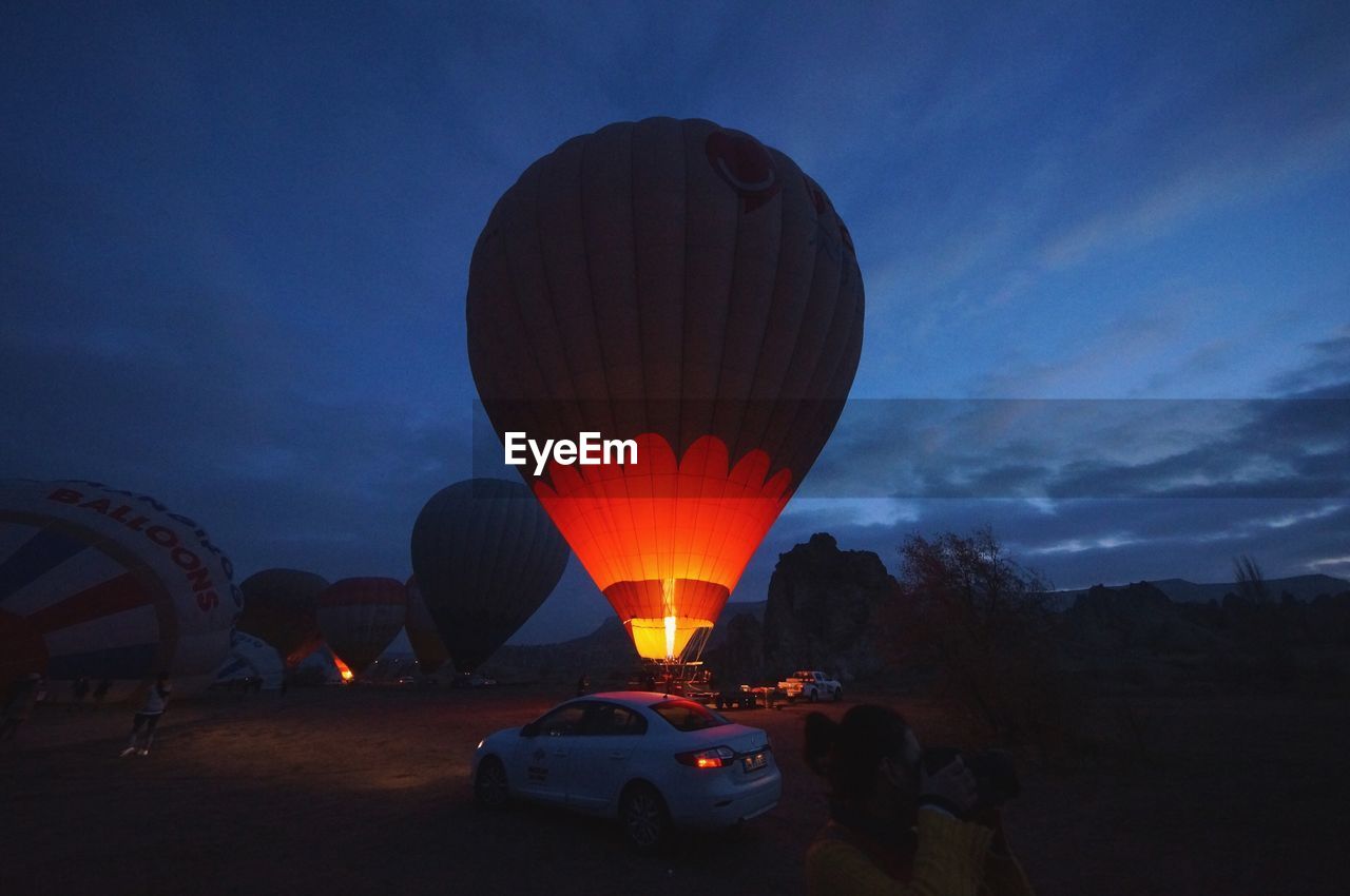 ILLUMINATED HOT AIR BALLOON AGAINST SKY