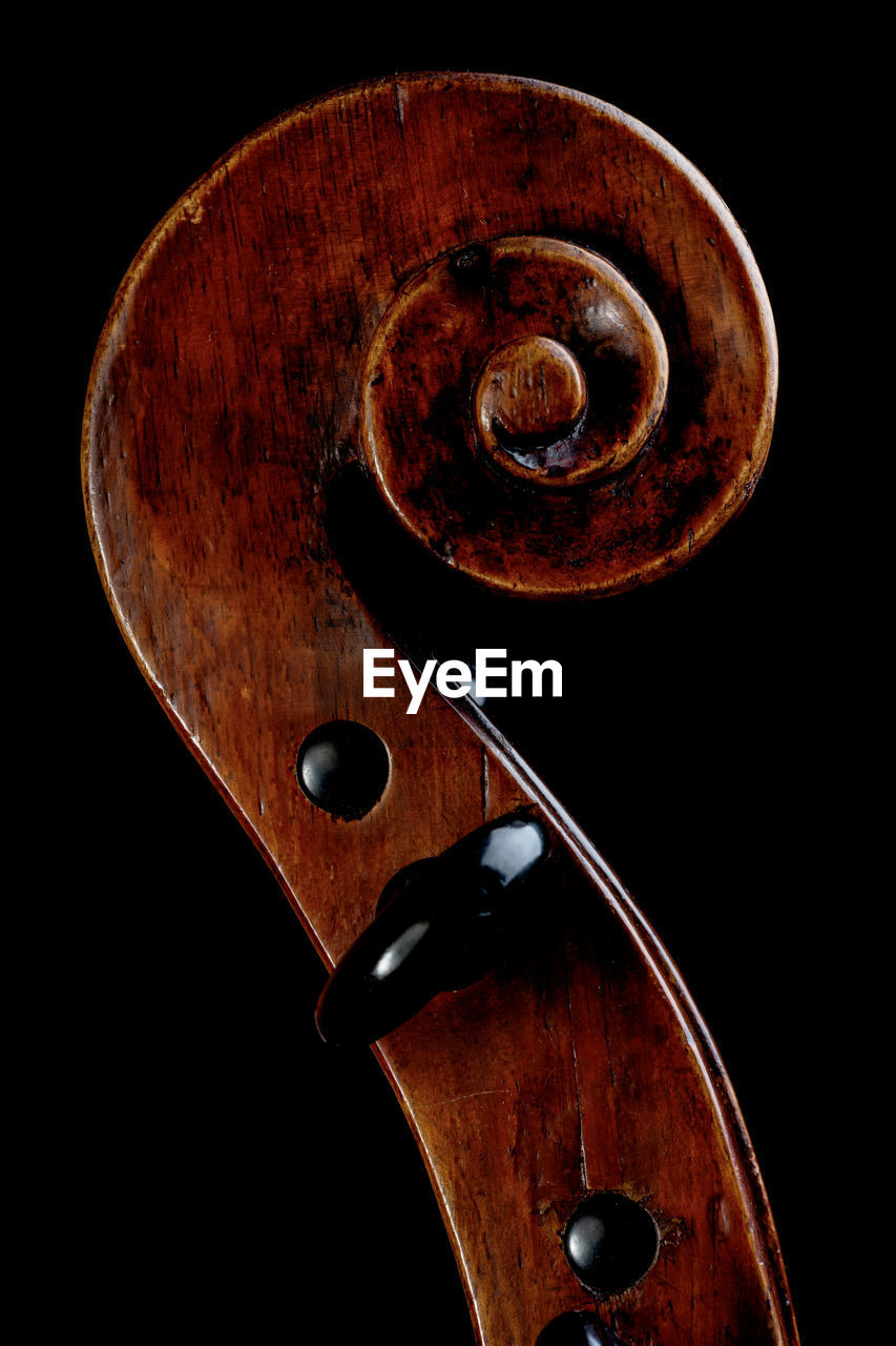 Close-up of violin against black background