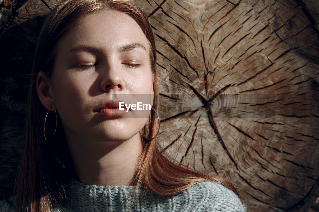 Close-up portrait of beautiful young woman with eyes closed