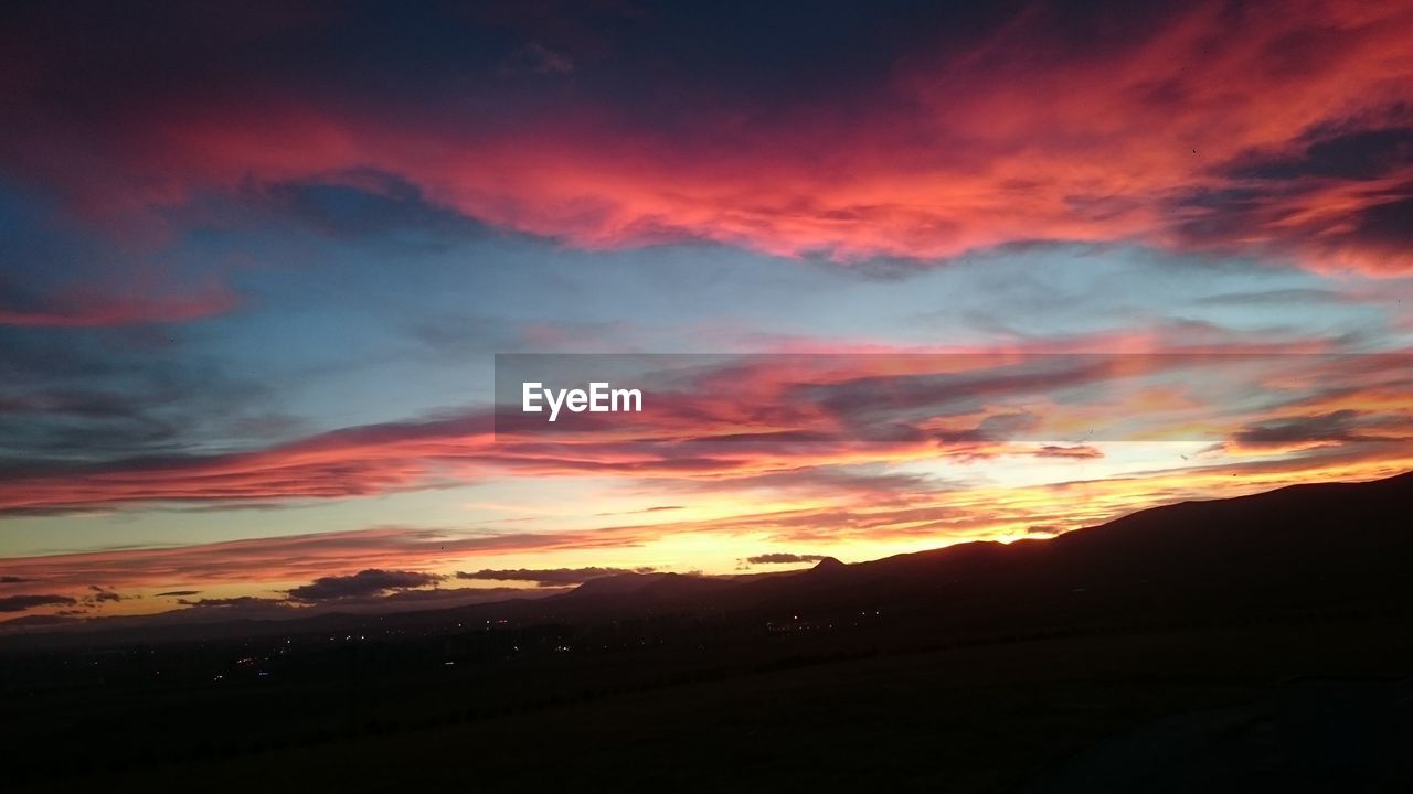 Scenic view of dramatic sky over landscape