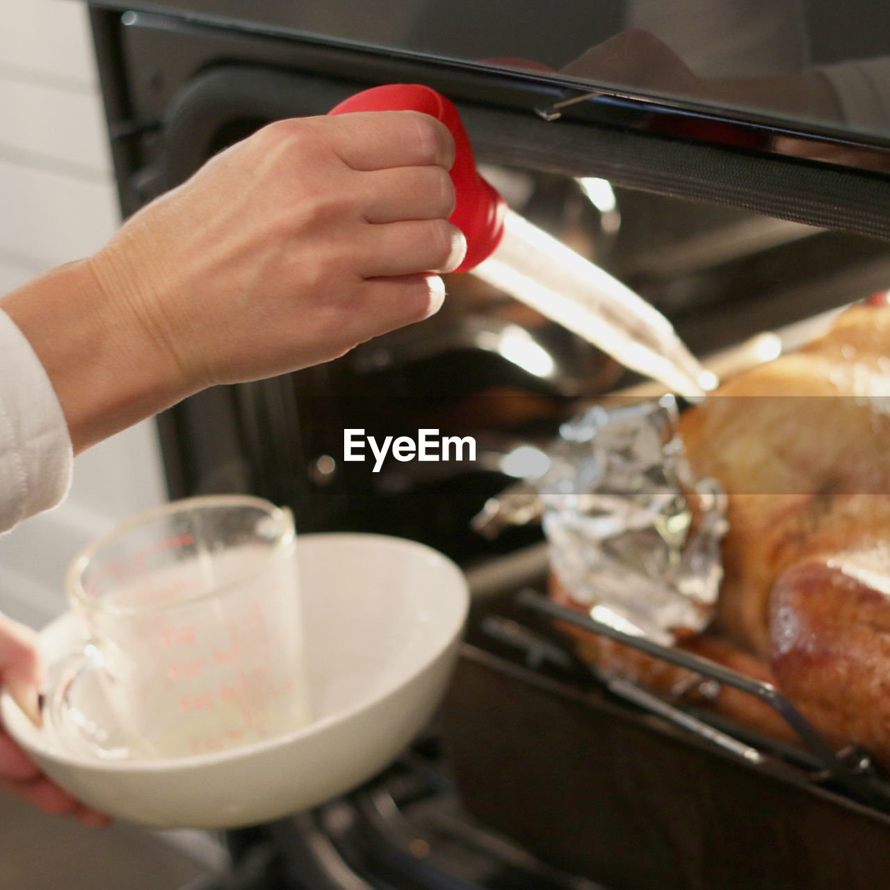 Cropped hand of woman preparing food in microwave