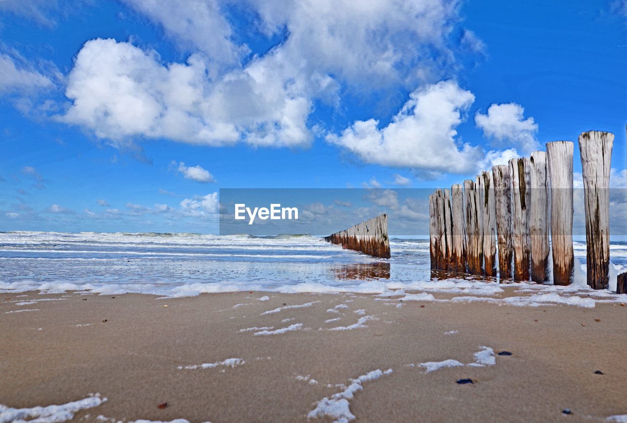 Scenic view of beach against blue sky