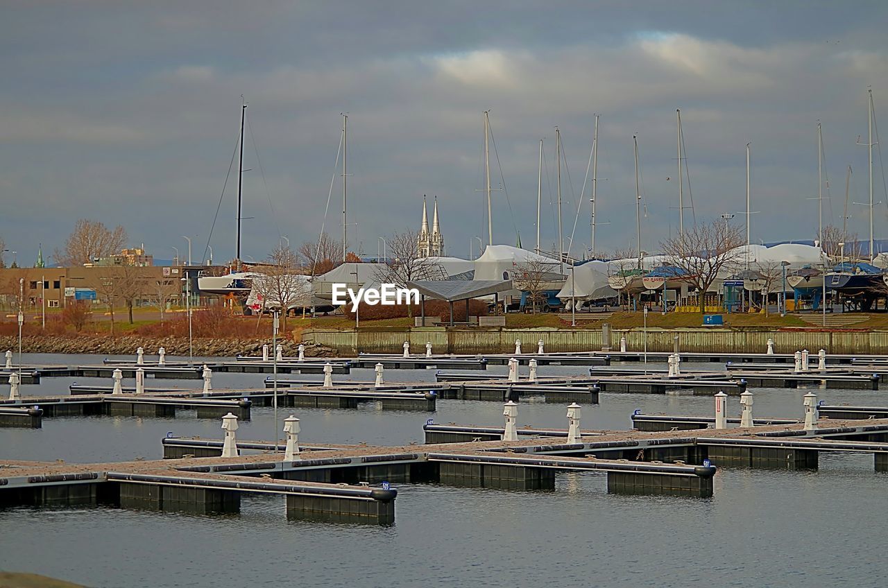 BOATS MOORED AT HARBOR