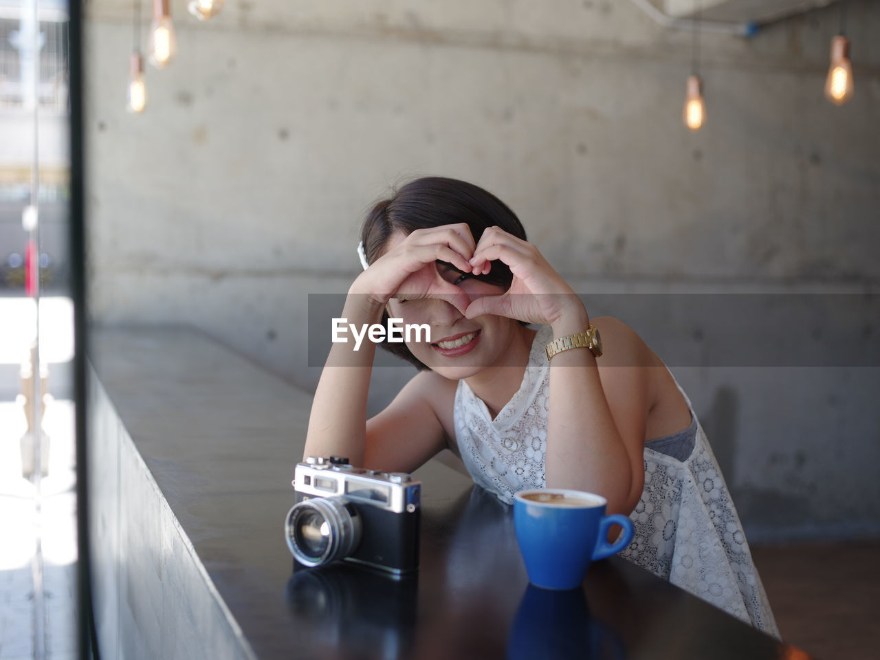 Portrait of smiling young woman sitting at cafe