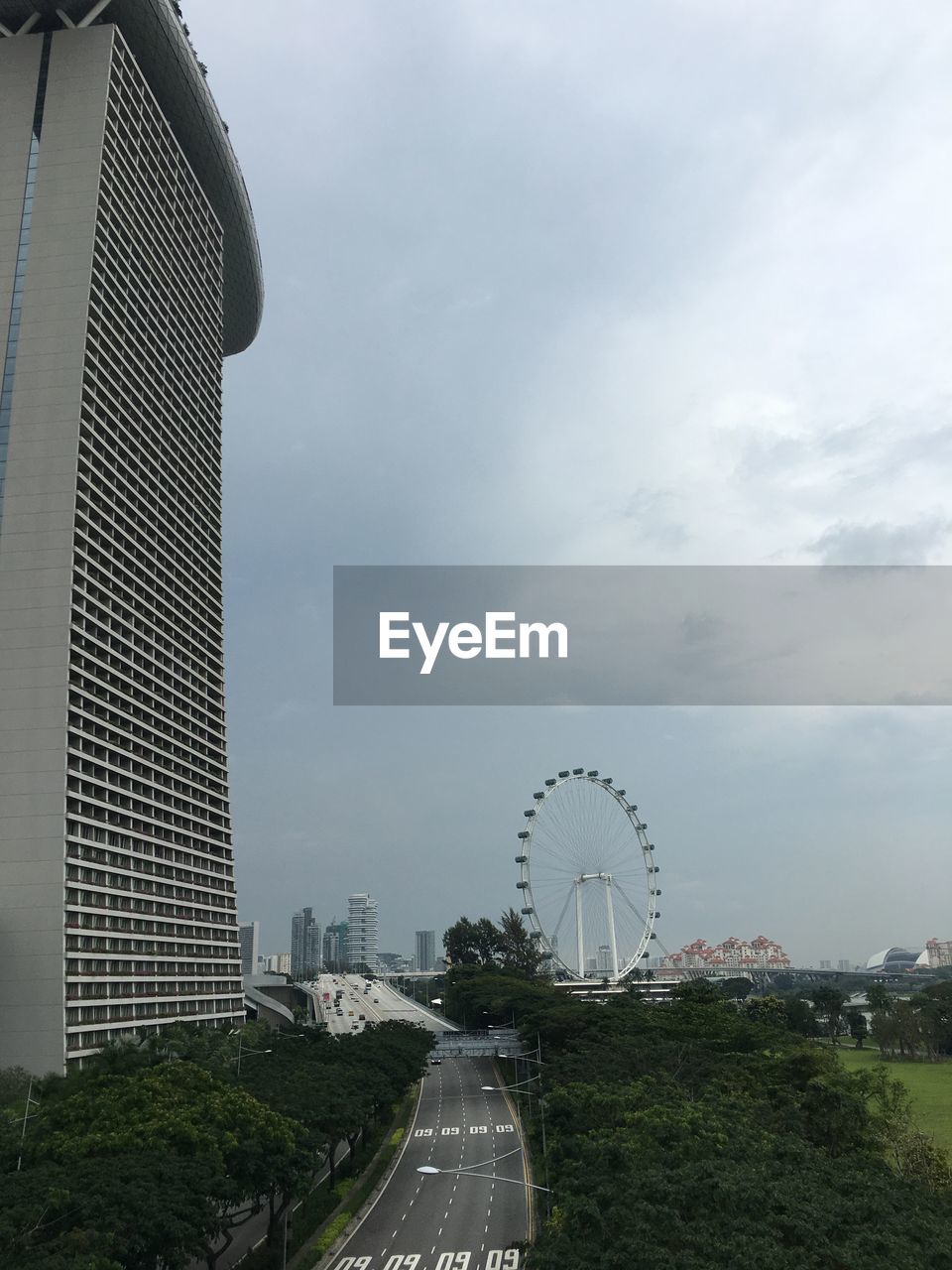 ROAD AMIDST BUILDINGS AGAINST SKY