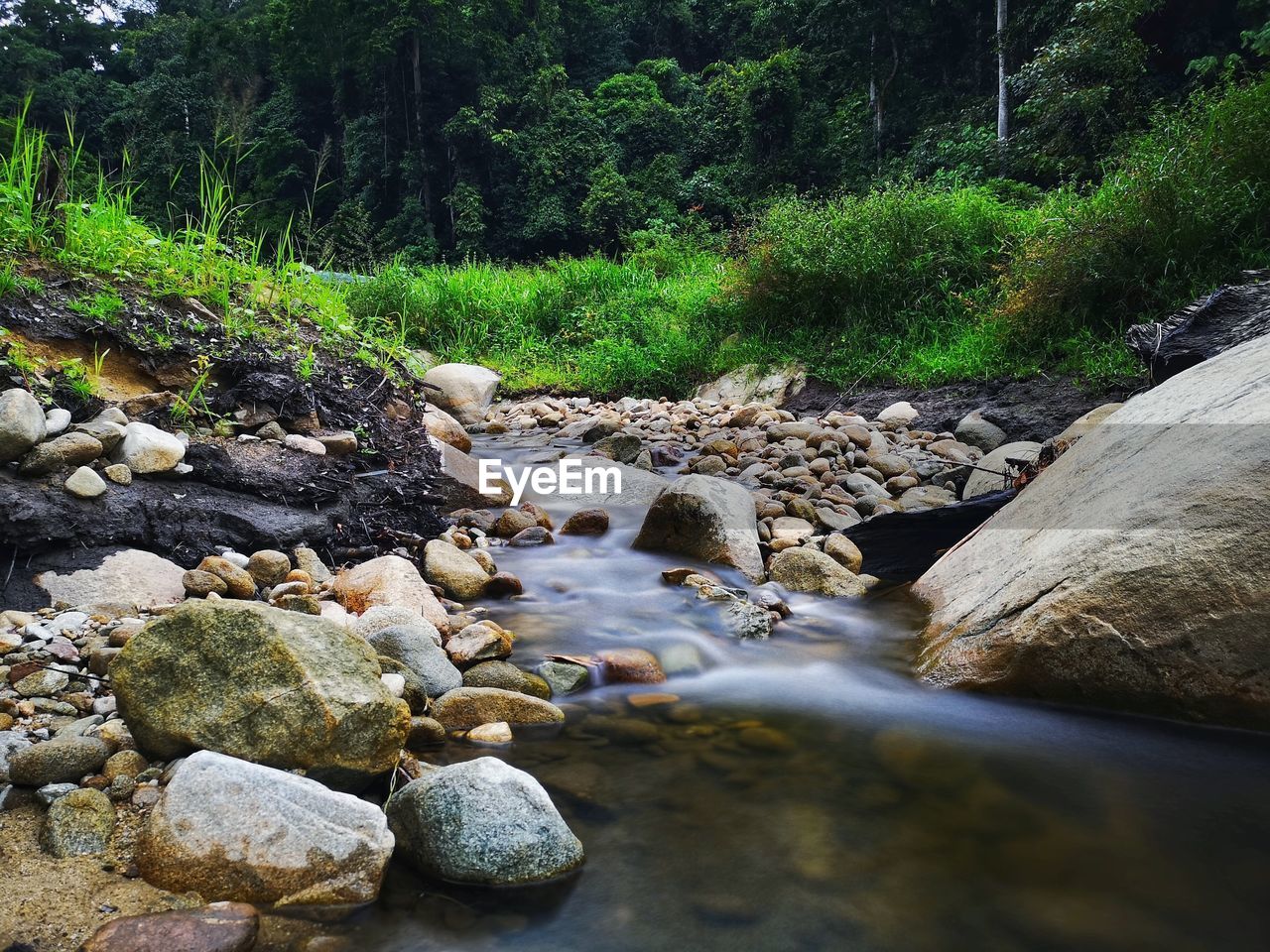 VIEW OF STREAM FLOWING THROUGH ROCKS