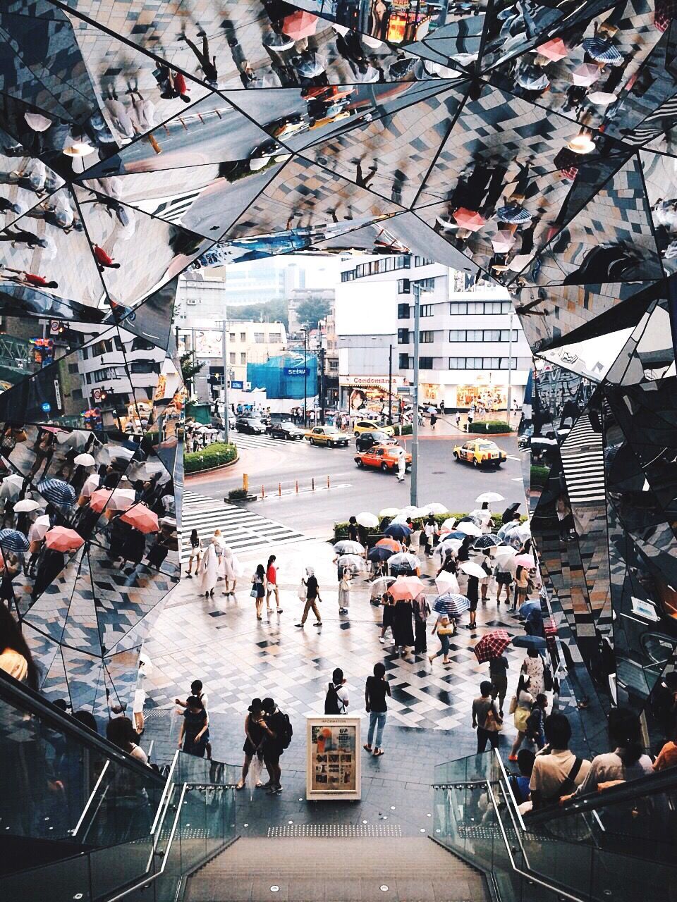 High angle view of people on street seen through building